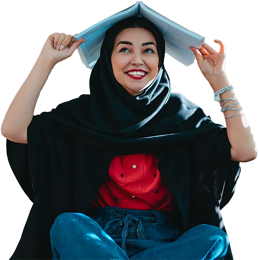 female student holding a book over head