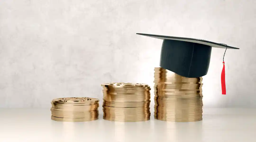 coins and graduation hat depicting scholarship